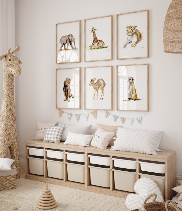 Children's room with framed animal prints on the wall and a wooden storage unit.