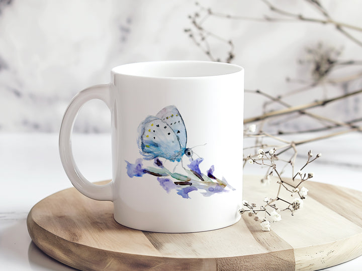 Witte mok met blauwe vlinder op tafel met decoratie