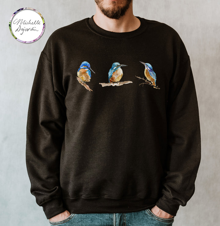 Black sweatshirt with bird design worn by a person on a gray background