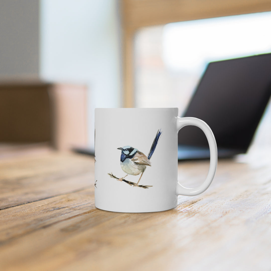 White mug with a bird design on a wooden surface