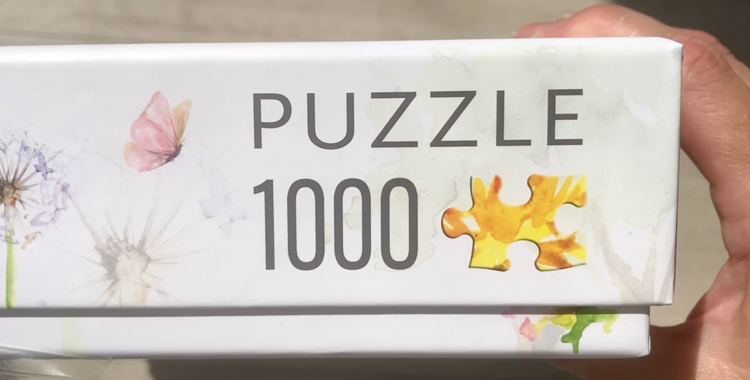 Close up of jigsaw puzzle box with nature and bird illustrations