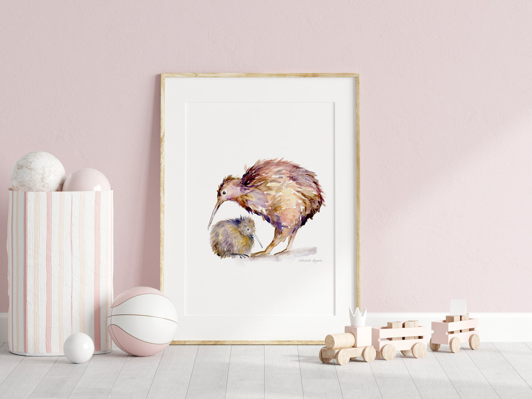Framed artwork of a kiwi on a pink wall with decorative items below.
