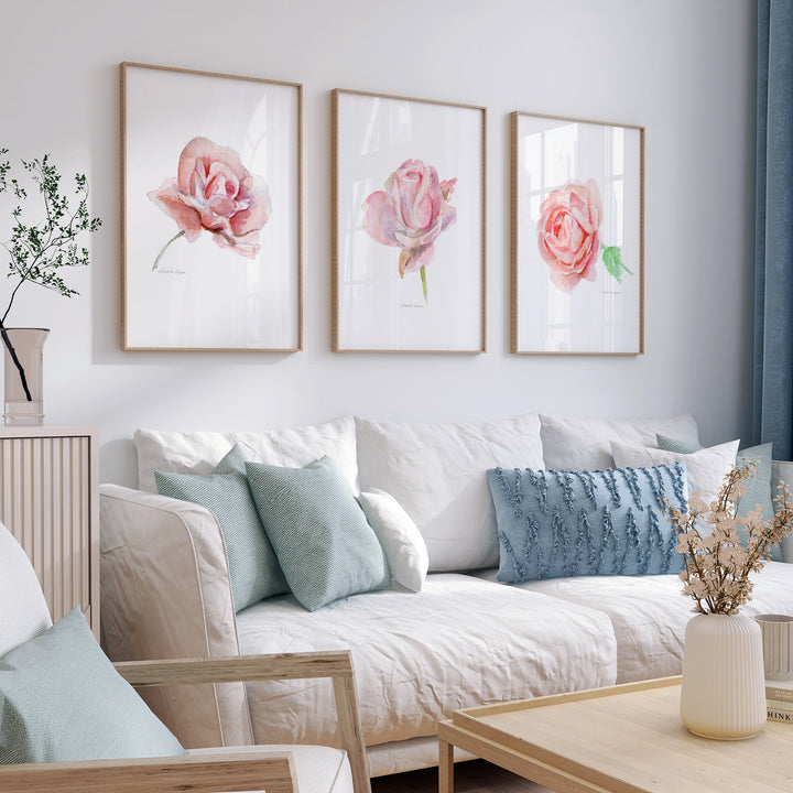 Living room with a white sofa, decorative pillows, and floral roses wall art.