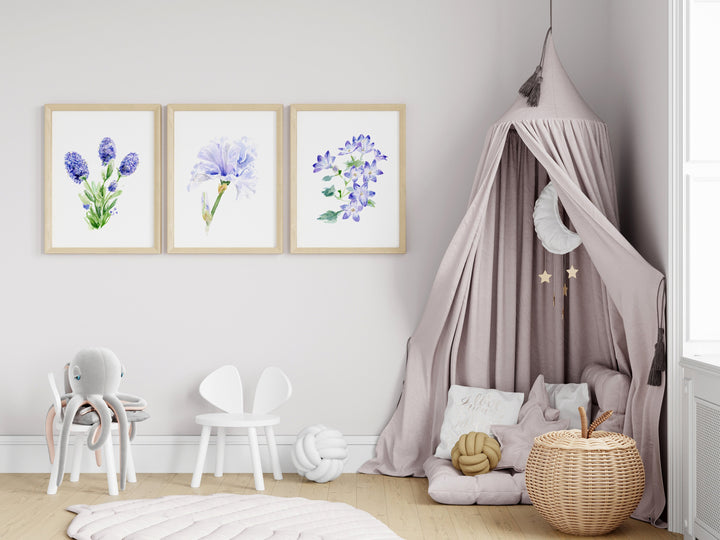 Children's room with floral wall art, pink canopy, and white chairs.