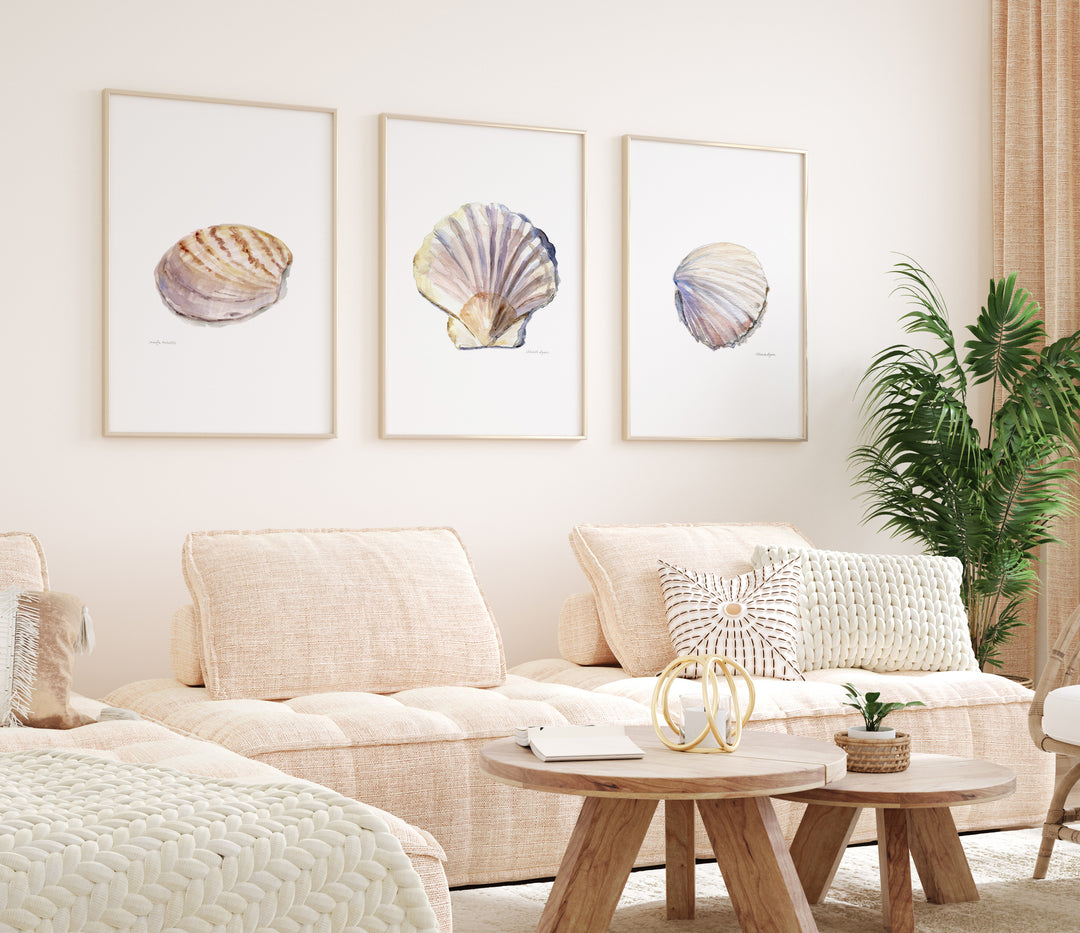 Living room with beige sofa, wooden coffee table, and shell-themed wall art.