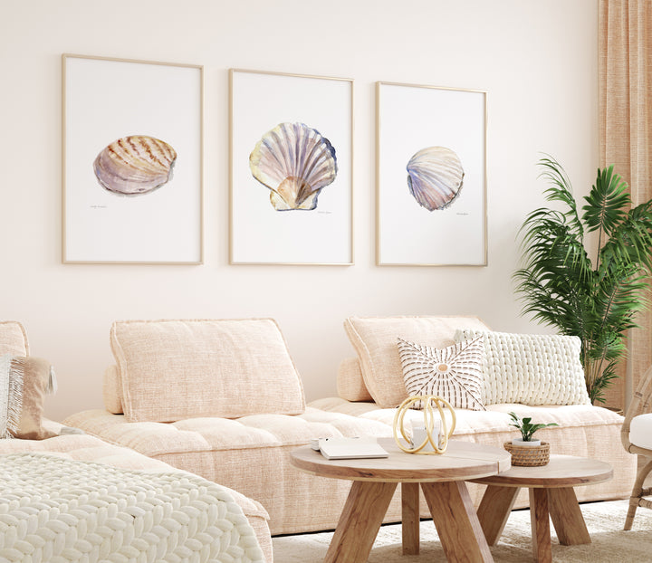 Living room with beige sofa, wooden coffee table, and shell-themed wall art.