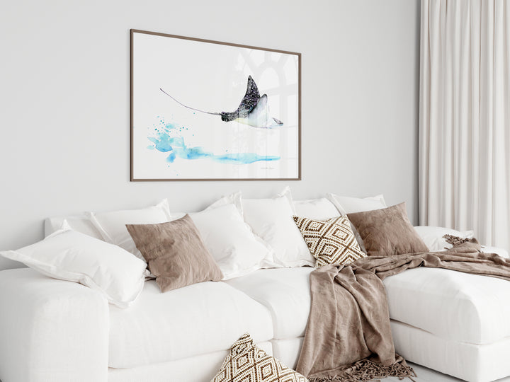 White sofa with decorative pillows and a framed artwork in a living room.