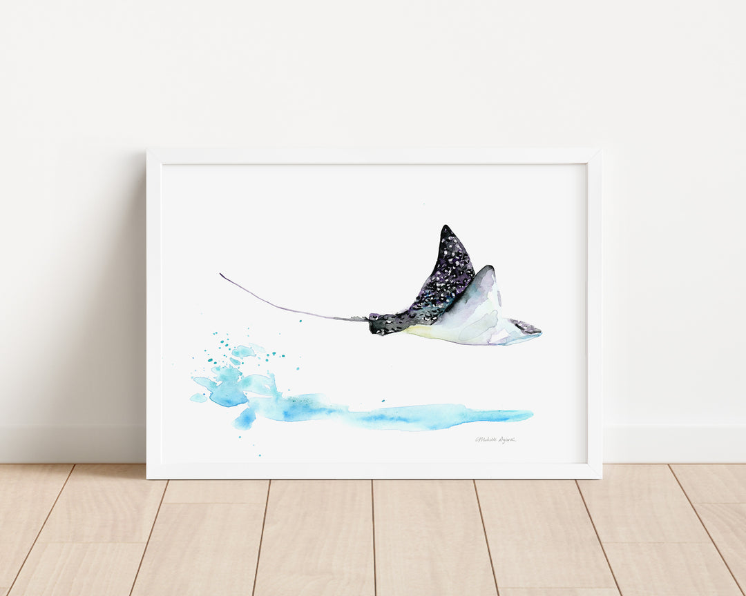 Framed artwork of a stingray on a white wall with wooden floor.