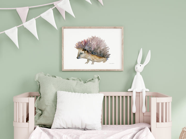 Children's room with a crib, framed artwork of a hedgehog, and a bunny plush toy on a light green wall.