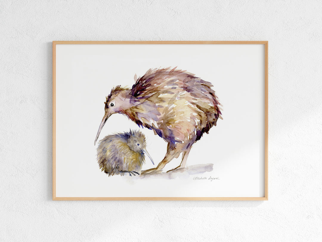 Framed artwork of two kiwi birds on a white wall