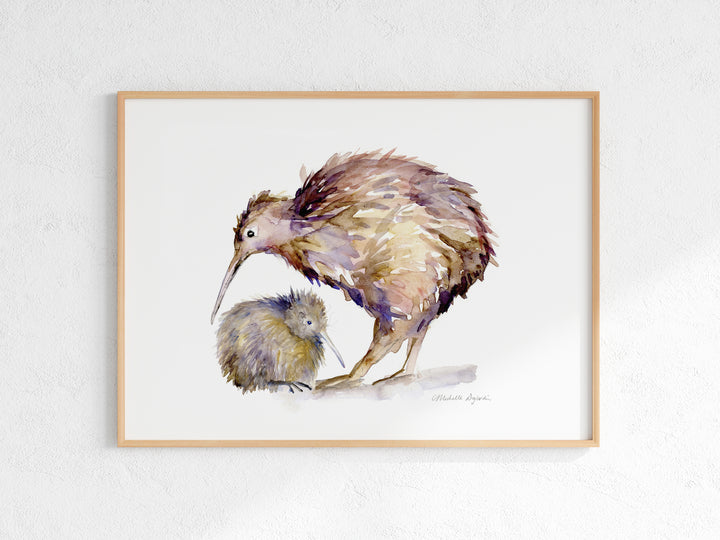 Framed artwork of two kiwi birds on a white wall