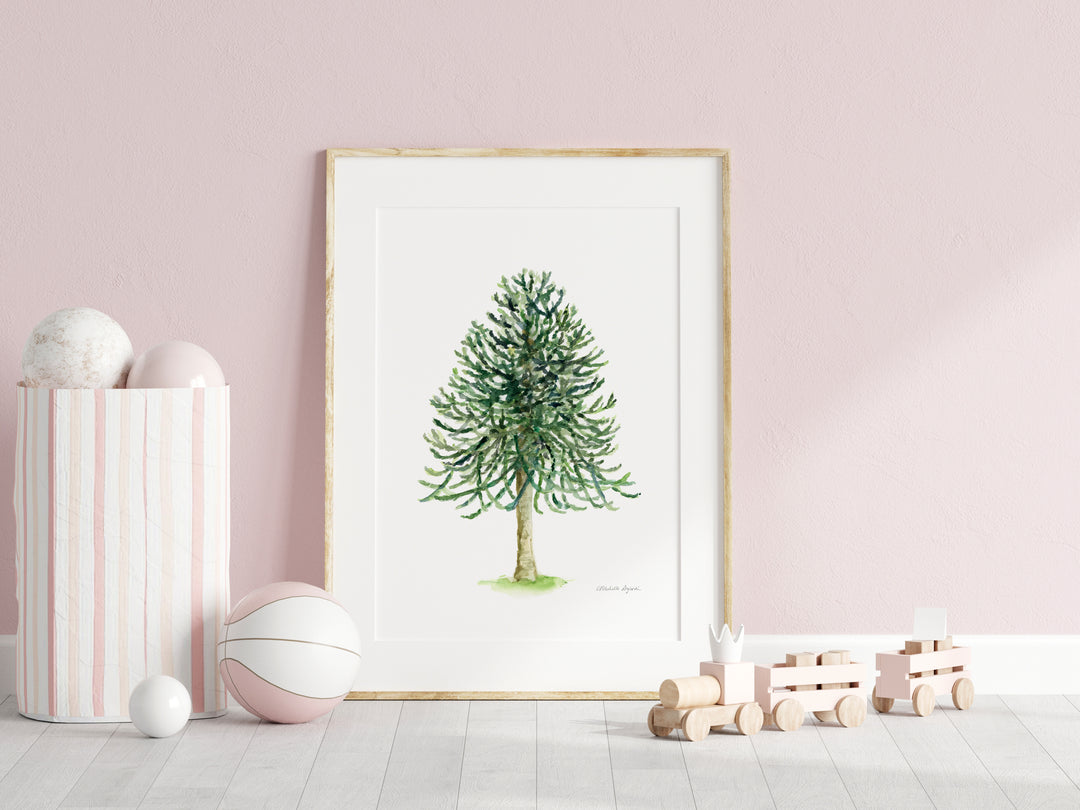 Framed artwork of a green tree on a pink wall with decorative items.