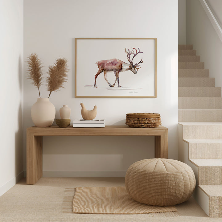 Wooden console table with decorative items and reindeer print in a room with a staircase.