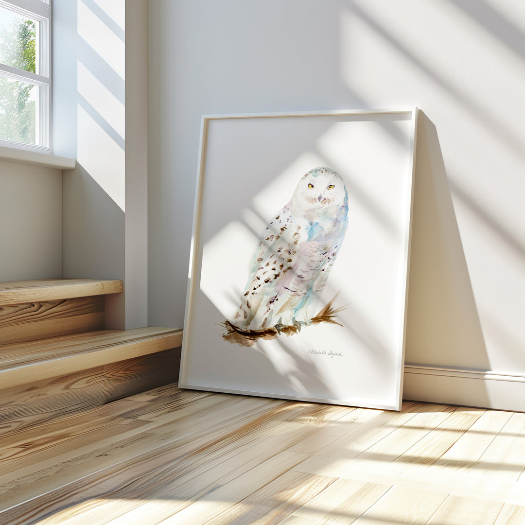 Framed artwork of an owl on a wooden floor with sunlight streaming in