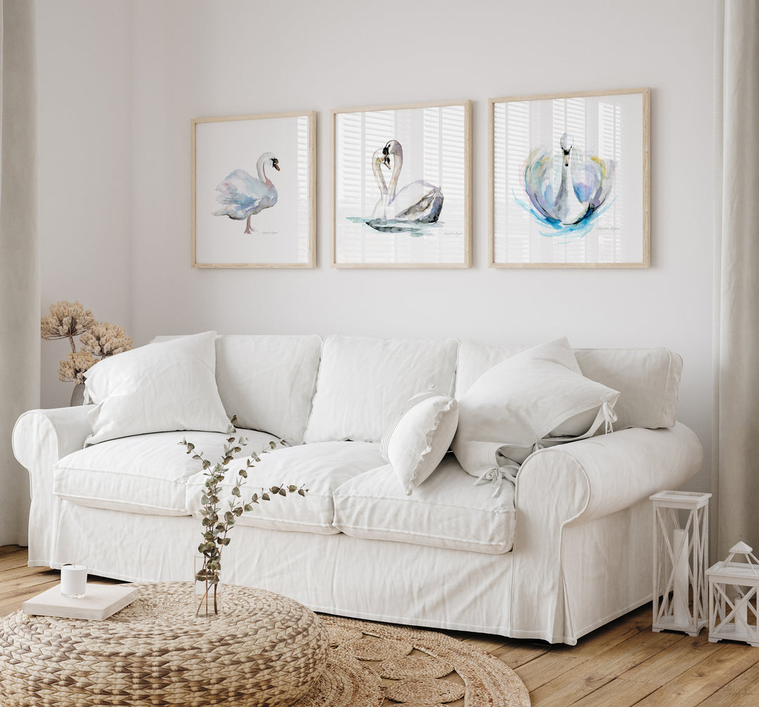 White sofa in a living room with framed swans artwork on the wall
